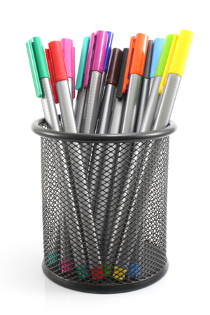 colored Pens  in iron basket on the white backgroundの写真素材