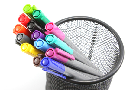 colored Pens  in iron basket on the white backgroundの写真素材