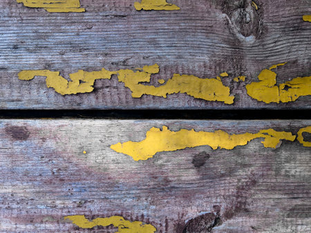 Texture of old shabby brown wood planks background with peeling yellow paint.の写真素材
