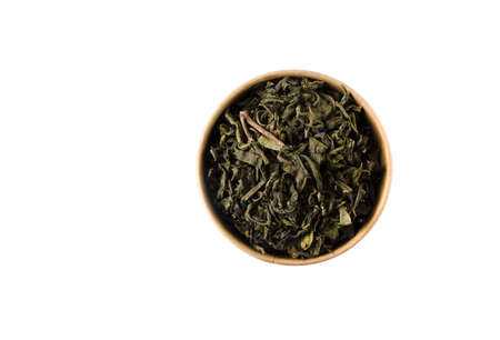 Green tea in reusable round cardboard packaging isolated on white background. View from above.