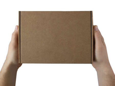 A parcel cardboard box in a men hands on a white background. Delivery service concept.