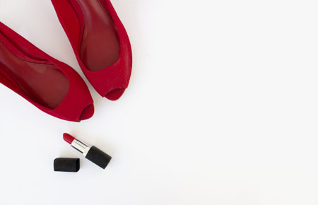 Red shoes and red lipstick on a white background. Beauty blog concept. Flat lay. top viewの写真素材
