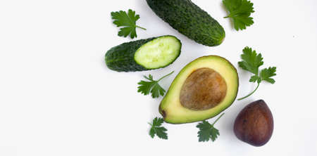 Avocado, cucumber and parsley on white isolated background. Place for text