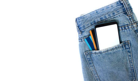 Mockup Smartphone with empty screen and credit cards in pocket jeans on white isolated background....