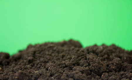bio ground or soil substrate as frame or border isolated on green background. Place for text, copy spaceの写真素材