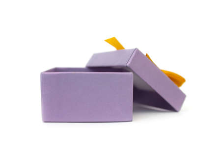 Blank open purple gift box with yellow ribbon bow isolated on white backgroundの写真素材