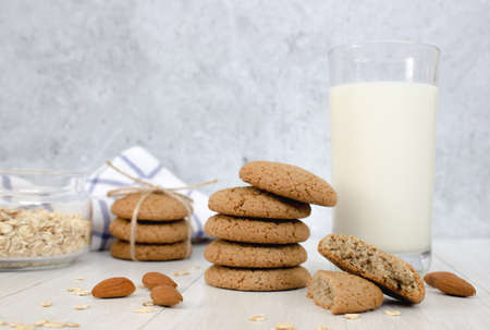 Oatmeal cookies and a glass of milk on a light background