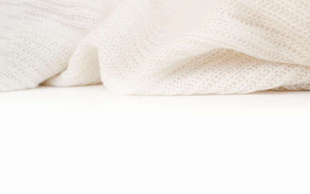 White knitted winter sweater on a white background, place for textの写真素材