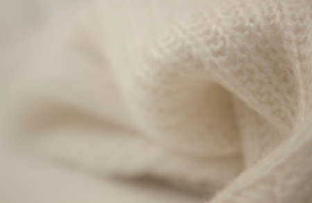 Background from white knitted sweater, selective focusの写真素材