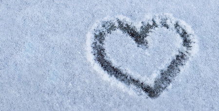 Close up painted heart in the snow. Place for text. Symbol of love, romance, Valentines Day