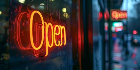 Neon orange sign with the word Open hanging on a glass door. High quality photoの素材