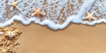 A beautiful starfish lies on the sand next to a wave approaching it, view from above. High quality photoの素材