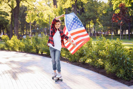 A young guy American riding at the speed on a skateboard.
