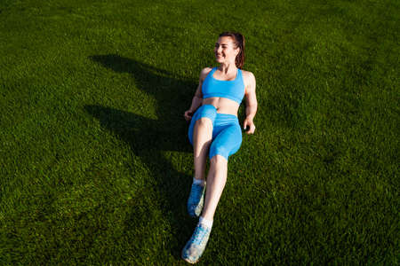 Beautiful, attractive, charming brunette having fun at the football stadium on a warm summer...