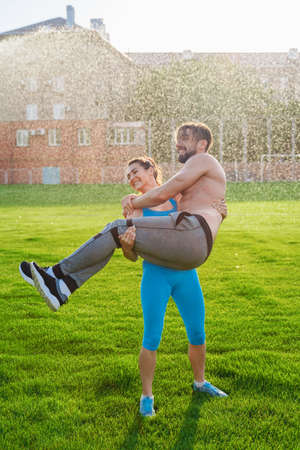 Athletic muscled young woman in a sports wearing doing fitness exercises. Fitness woman posing at the stadium. Healthy athletic lifestyle.の写真素材