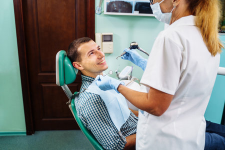 Close-up of a smiling, happy patient. Came for an examination to the clinic. No dental problems were found. Smooth, white teeth that do not require medical intervention. Big smile in the dental chair.の写真素材