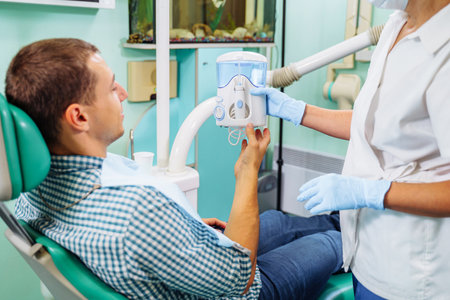 Importance of dental irrigator in effective oral care. Cleansing the cavity between the teeth. Dental appliance for household use. Hydro Floss Oral Irrigator System-Prevents Gum Disease naturally.の写真素材