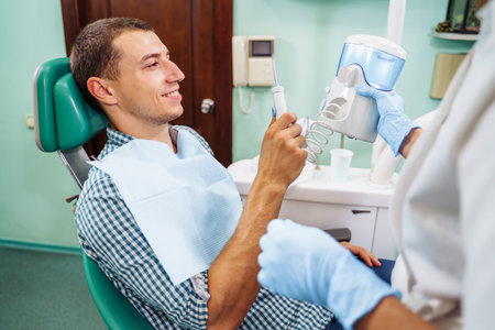 Importance of dental irrigator in effective oral care. Cleansing the cavity between the teeth. Dental appliance for household use. Hydro Floss Oral Irrigator System-Prevents Gum Disease naturally.の写真素材