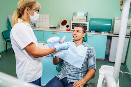 Importance of dental irrigator in effective oral care. Cleansing the cavity between the teeth. Dental appliance for household use. Hydro Floss Oral Irrigator System-Prevents Gum Disease naturally.の写真素材