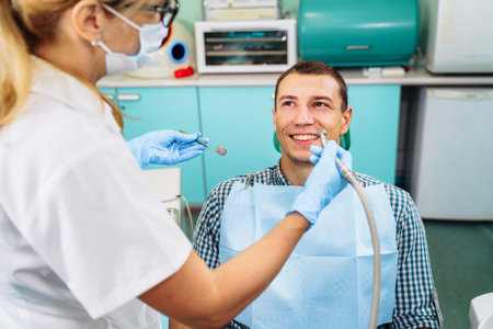 Close-up of a smiling, happy patient. Came for an examination to the clinic. No dental problems were found. Smooth, white teeth that do not require medical intervention. Big smile in the dental chair.の写真素材
