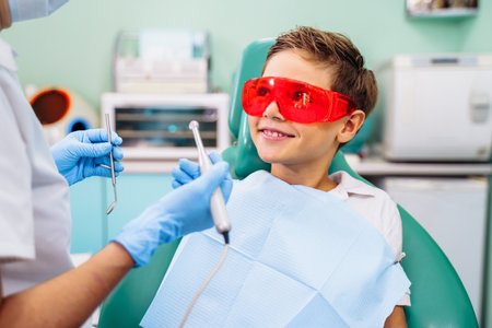 Protection of vision, eyesight against bright light and radiation from dental device with red or orange specialized glasses. Patient comfort comes first. Appointment at professional dentist in clinic.の写真素材