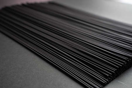 Black dry raw noodles spaghetti on dark backgroundの写真素材
