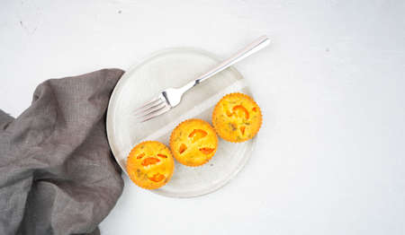 Small egg bite food pastry muffins on a gray ceramic plate handmade with a gray linen napkin and a gray background with a chrome fork. Finger food and mini meals concept. Mock up. Copy spaceの写真素材