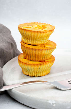 Small egg bite food pastry muffins on a gray ceramic plate handmade with a gray linen napkin and a...