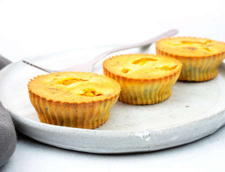 Small egg bite food pastry muffins on a gray ceramic plate handmade with a gray linen napkin and a gray background with a chrome fork. Finger food and mini meals concept. Mock up. Copy spaceの写真素材