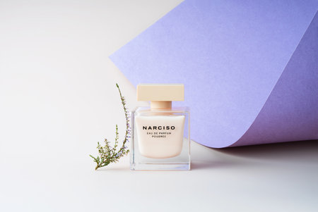 Kirov Russia 15 November 2020 Bottle Narciso Rodriguez poudree eau de Parfum on a delicate white and lilac background with a stylish flowerのeditorial素材