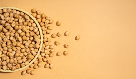 Chickpeas in small yellow ceramic plate bowl isolated on beige background.vegetarian dish. style minimalism. on bowl close up - concept healthy vegan diet protein organic brain food dishの写真素材