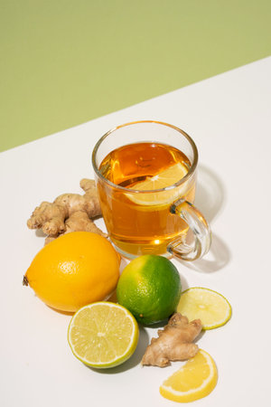 Hot herbal tea with ginger, lemon and honey vitamins C over gray background. Concept alternative medicine, natural homemade remedy for cold and flu. Support the immune system. Well-Being and Healtyの写真素材