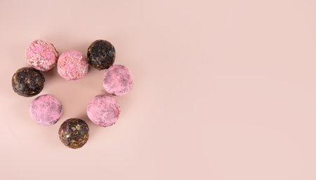 Homemade pink matcha energy balls in hearth candy gift box february 14, valentine's day. on a pink background top view, healthy sweets made of nuts and prunes. Concept postcard vegeterian diet sweet brain food. Copy spaceの写真素材