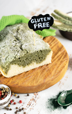 Homemade Spirulina bread, made from gluten-free rice and flax flour On a wooden oak board. superfoods. Concept wellness and healthy vegeterian food. Close upの写真素材