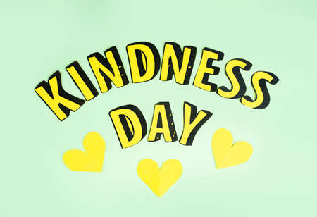 Happy Random Acts of Kindness Day February 17. Calendar on workplace paper letters Text Effect on olive green Background and yellow hearts from handmade paper. Quilling.Empty space for text, Copy spaceの写真素材