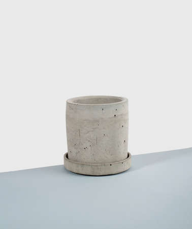 Creative diagonal isometric projection. Composition with concrete flower pot. blue and white background. Minimalism. Natural material.の写真素材