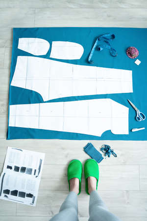 young Woman working at home with a sewing design pattern. Concept diy hobby handcrafted. Mental...