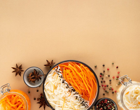 Homemade village fermented sauerkrauts and korean carrot. star anise, black and red pepper.Vegan salad in ceramic bowl. Probiotics gut health concept. Superfood on Creative beige background, copy spaceの写真素材
