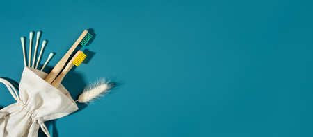 Zero waste concept.linen bag, ear stick. bamboo toothbrushs, trendy shadows, aquamarine background....