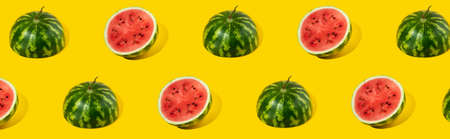 Pattern of sliced fresh watermelon on yellow background. Summer fruit, berry. Bold color. Trendy, Minimal shadows. Watermelon day concept -3 august.の写真素材