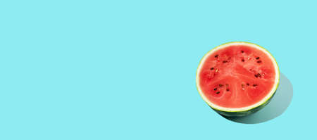 sliced fresh watermelon on blue background. Summer fruit, berry. Bold color. Trendy, Minimal...