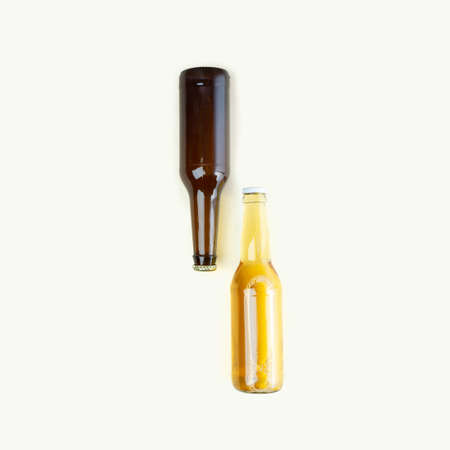 A bottles of craft beer on beige background. International beer day or Octoberfest concepts.Resting and Drinking beer after a hard working day in the home.Minimalistic colors on a photo.Copy spaceの写真素材