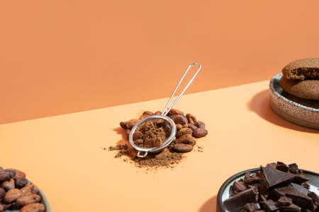 Creative isometric diagonal projection composition with healthy ingredient organic cocoa products: beans, powder on a ivory background. Concept healthcare, energy superfood, brain food. Copy spaceの写真素材