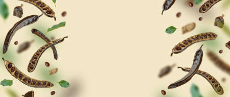 Creative composition. Floating Organic carob pods, seeds, leafs. food background. Natural vegan...