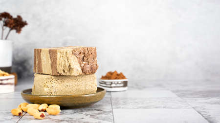 Tasty eastern sweet dessert halva from sunflower seeds, cocoa and tahini on gray background.Traditional dessert confection in Middle East, Balkans and west Asia.Horizontal.Copy spaceの写真素材