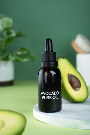 Rose flowers with aromatherapy essential rose oil in a glass bottle over very peri background. wellbeing concept.の写真素材