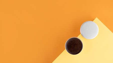 Homemade cosmetics with coffee scrub and oil. Set of home SPA eco-friendly cosmetic products. Anti-cellulite cosmetic for peeling and spa self-care on a beige yellow background. wellbeing conceptの写真素材