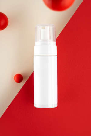 Creative copposition Skincare routine. Anti acne products for healthy skin on red background. Packaging of facial foam, cleansing, essence, serum, lotion. Beauty and natural cosmetic concept. Minimal.の写真素材