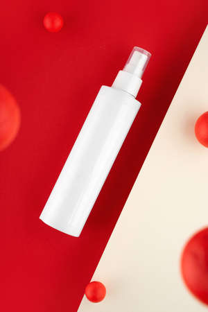 Creative copposition Skincare routine. Anti acne products for healthy skin on red background. Packaging of facial foam, cleansing, essence, serum, lotion. Beauty and natural cosmetic concept. Minimal.の写真素材