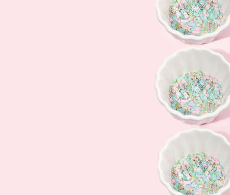 A plate full of microplastics on a pink background. Impact of microplastics in the food chain. The concept of plastic pollution. Composition of plate, fork and micro plastic. copyspace.の写真素材